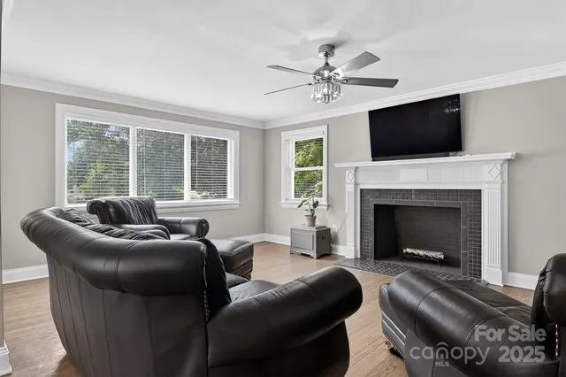 a living room with furniture a flat screen tv and a fireplace