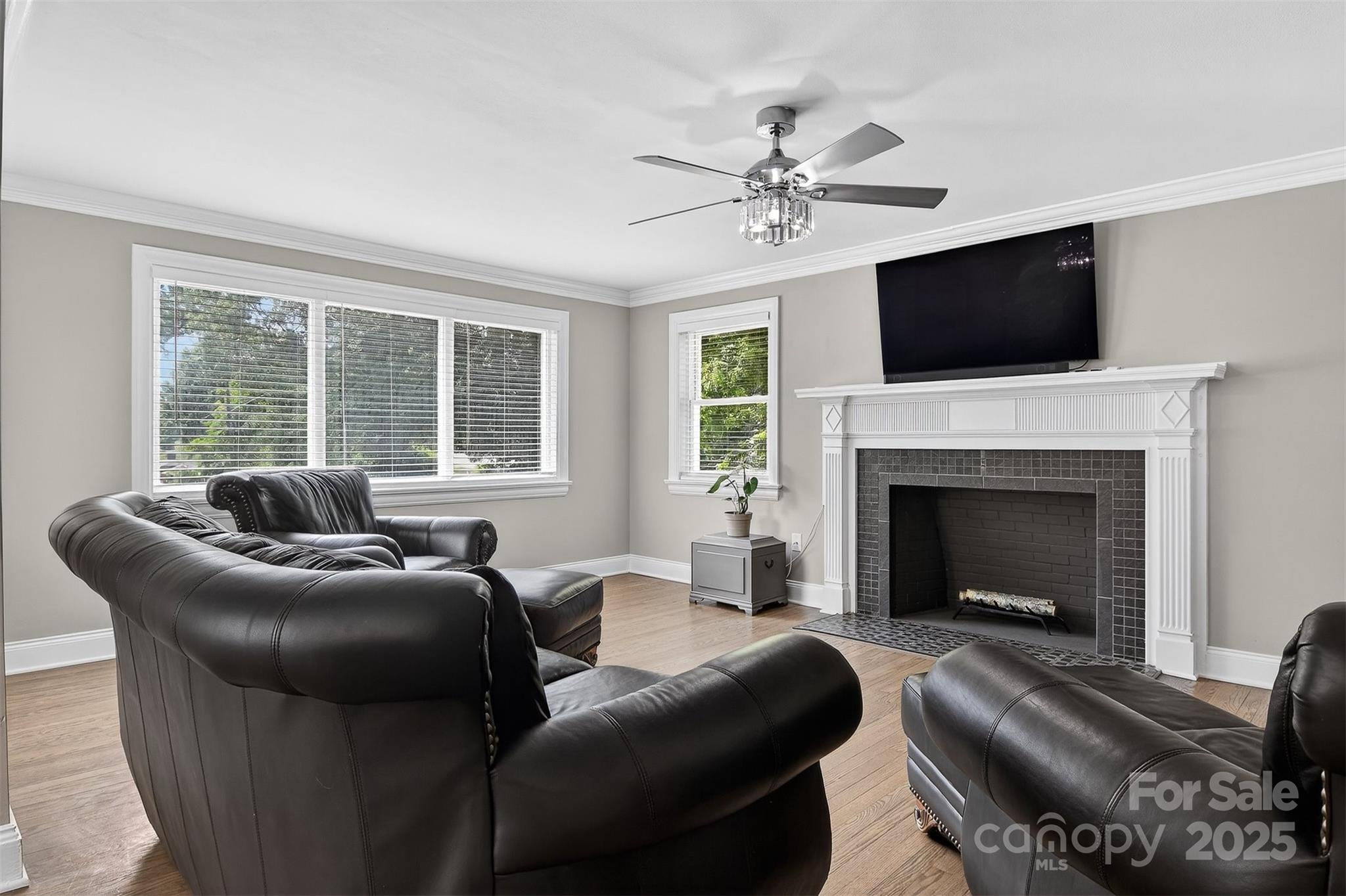 3127 North Center Street Hickory, NC 28601 - Photo 5 of 47 a living room with furniture a flat screen tv and a fireplace