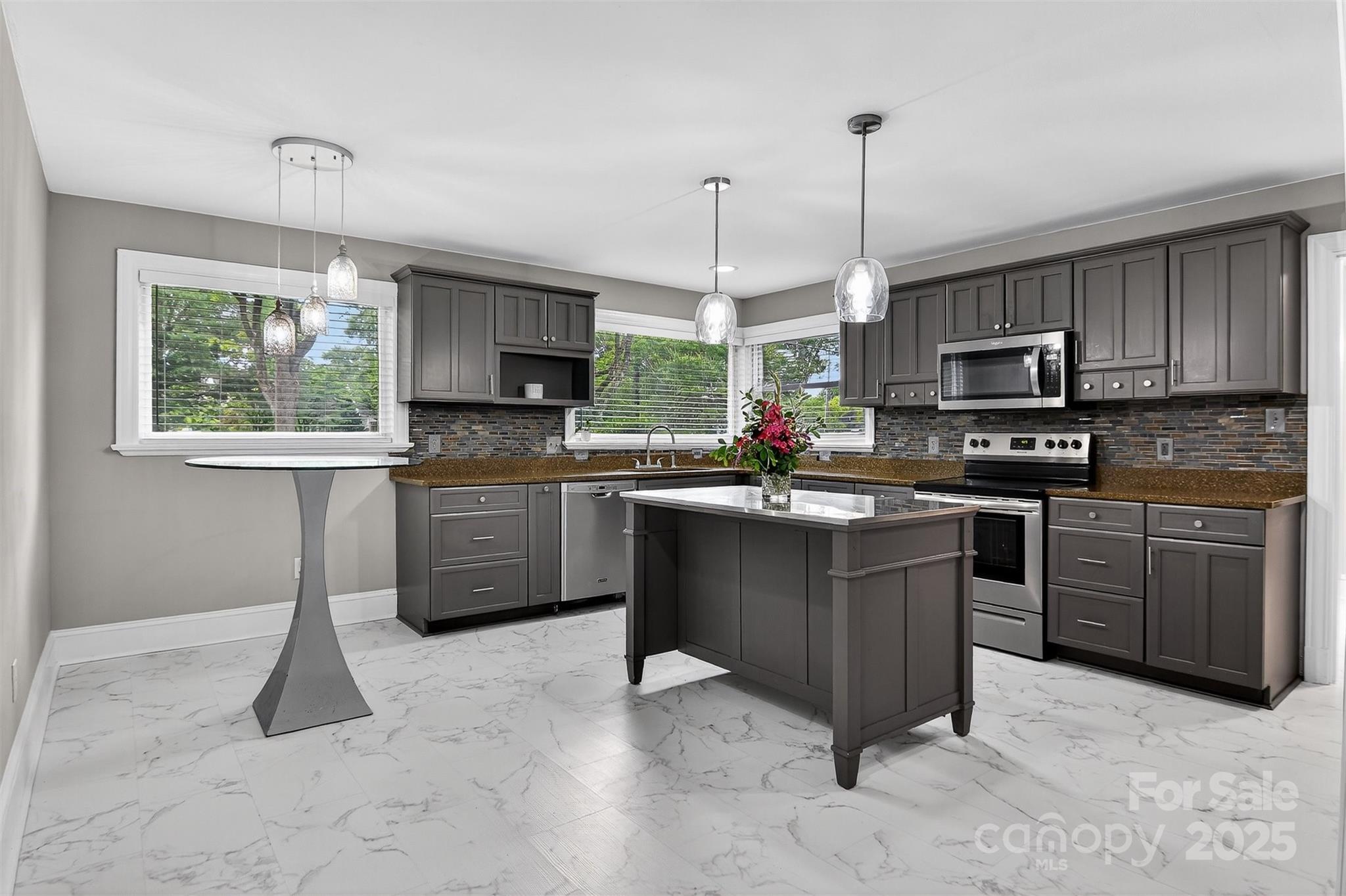 3127 North Center Street Hickory, NC 28601 - Photo 8 of 47 a kitchen with stainless steel appliances granite countertop a stove top oven a sink dishwasher a dining table and chairs