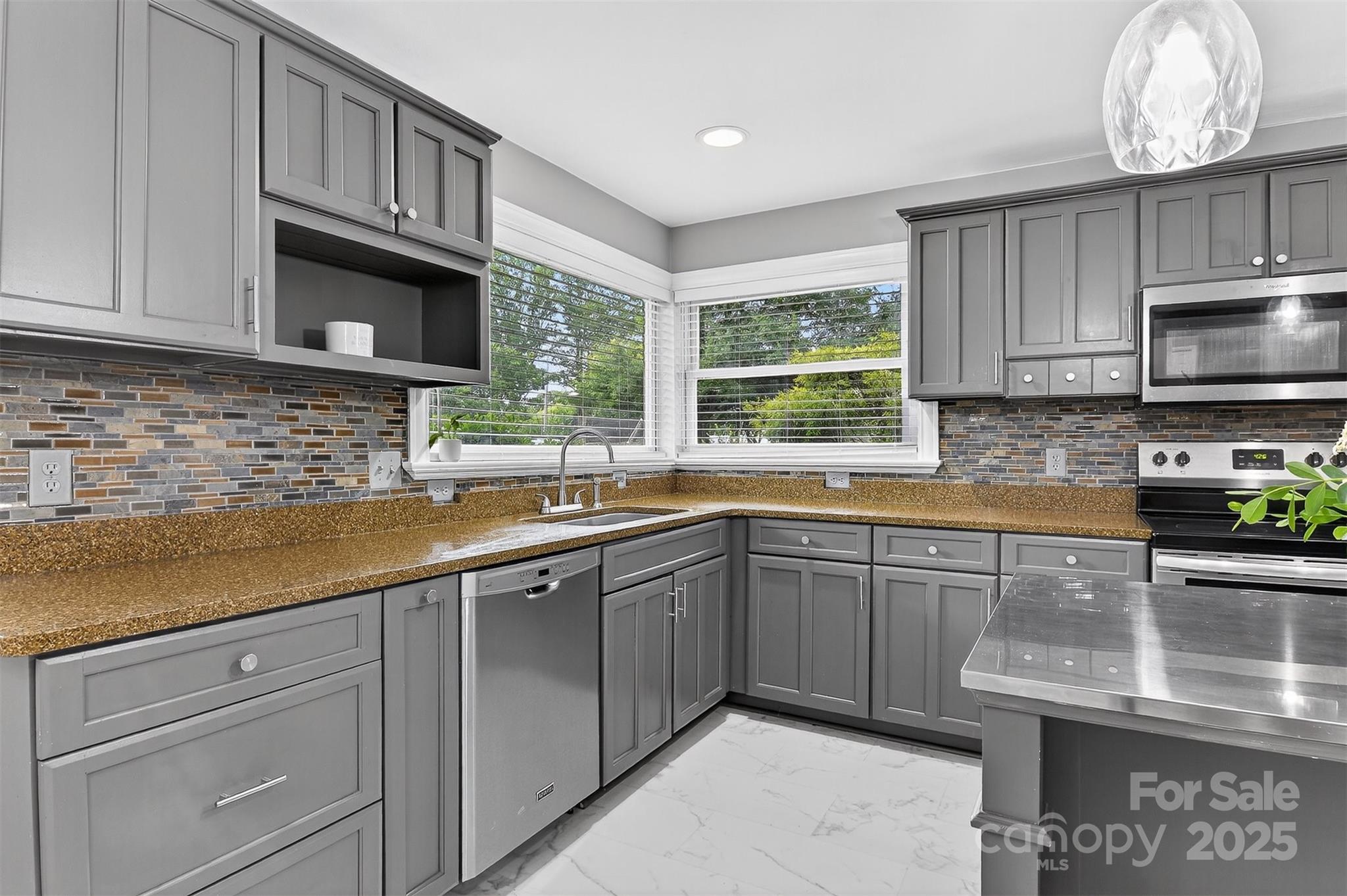 3127 North Center Street Hickory, NC 28601 - Photo 10 of 47 a kitchen with stainless steel appliances granite countertop a sink a stove and cabinets