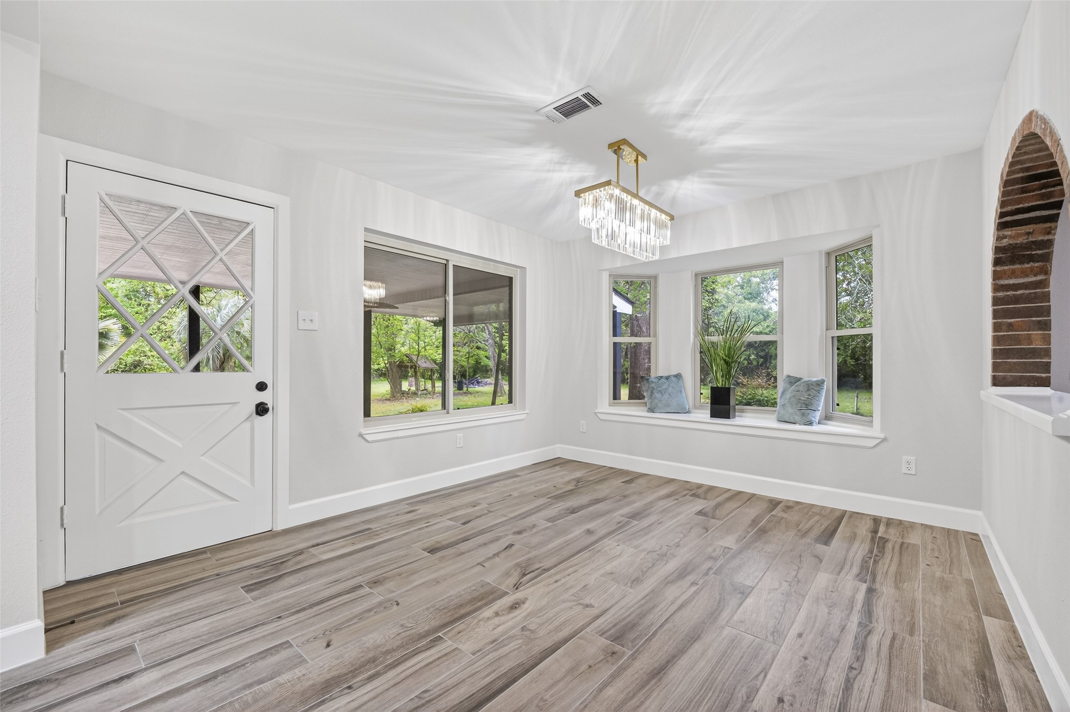 23607 Cardinal Drive Hockley, TX 77447 - Photo 12 of 50 Anchored by a bold rectangular chandelier, the dining area offers vistas through a broad window viewing the patio and a large bay window overlooking the grounds.
