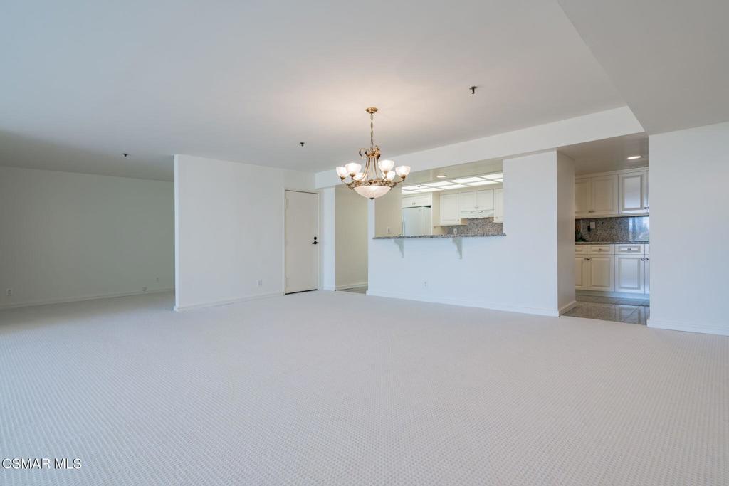 10660 Wilshire Boulevard, Unit 410 Los Angeles, CA 90024 - Photo 20 of 85 a view of a kitchen with a sink dishwasher a refrigerator and a chandelier
