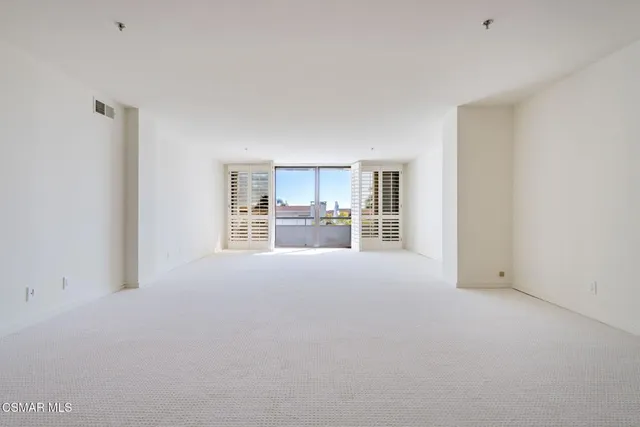 a room with a window and a kitchen