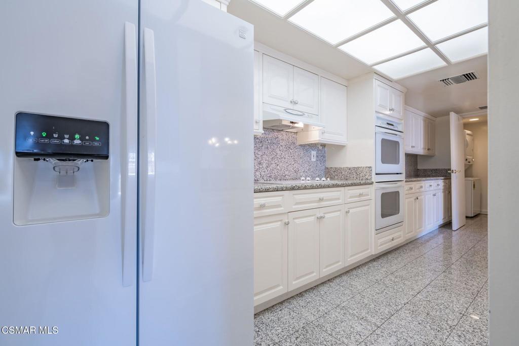 10660 Wilshire Boulevard, Unit 410 Los Angeles, CA 90024 - Photo 29 of 85 a large white kitchen with stainless steel appliances granite countertop a refrigerator and a sink