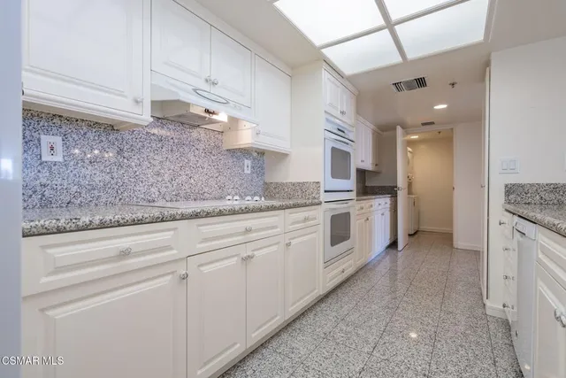 an empty room with an entrance to other room