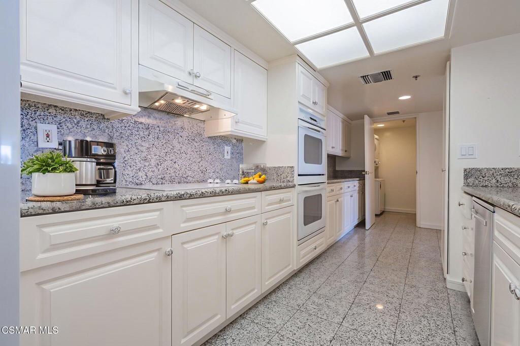 10660 Wilshire Boulevard, Unit 410 Los Angeles, CA 90024 - Photo 32 of 85 a kitchen with stainless steel appliances a sink stove and cabinets