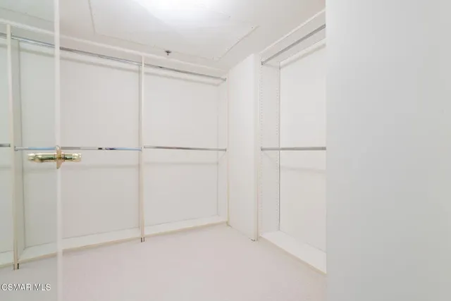 a large open kitchen with stainless steel appliances and large kitchen counter top