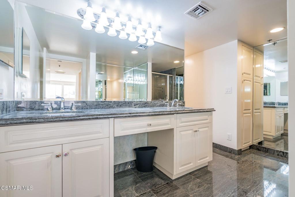 10660 Wilshire Boulevard, Unit 410 Los Angeles, CA 90024 - Photo 46 of 85 a bathroom with a sink and a mirror