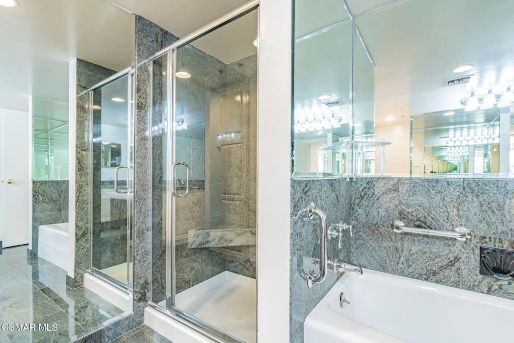 10660 Wilshire Boulevard, Unit 410 Los Angeles, CA 90024 - Photo 48 of 85 a bathroom with a bathtub and a shower
