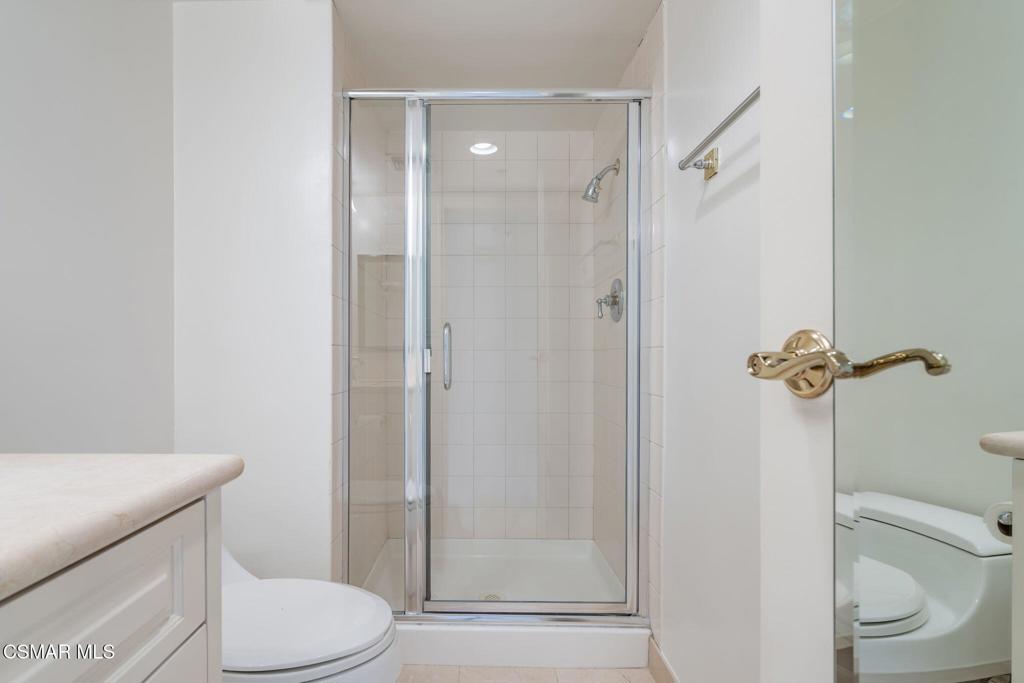 10660 Wilshire Boulevard, Unit 410 Los Angeles, CA 90024 - Photo 62 of 85 a bathroom with a granite countertop toilet a sink and shower