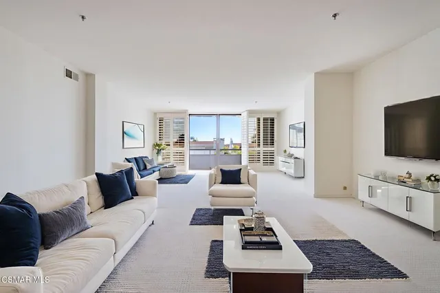 a dining area with granite countertop a table chairs refrigerator and microwave