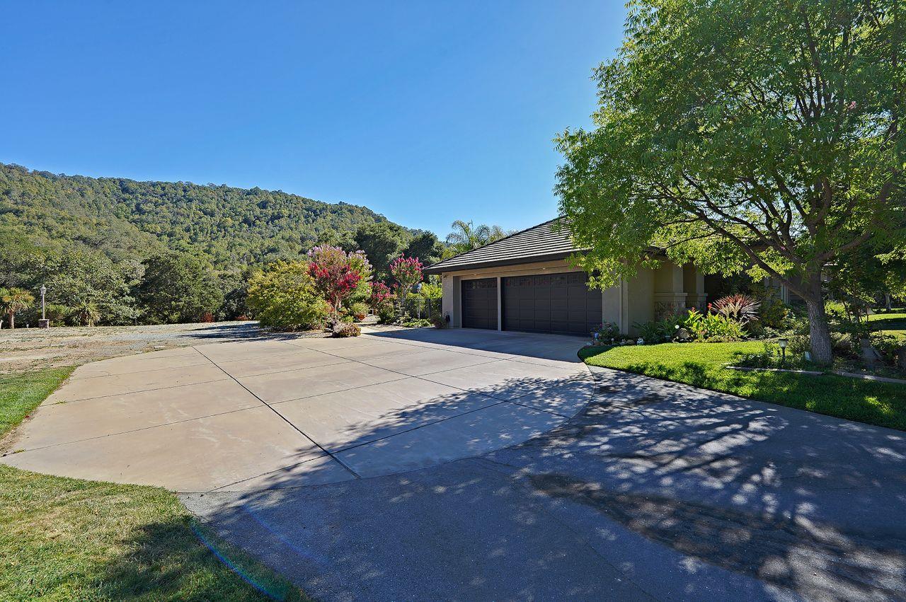 5000 Hecker Pass Road Gilroy, CA 95020 - Photo 49 of 100 a front view of a house with a yard and garage