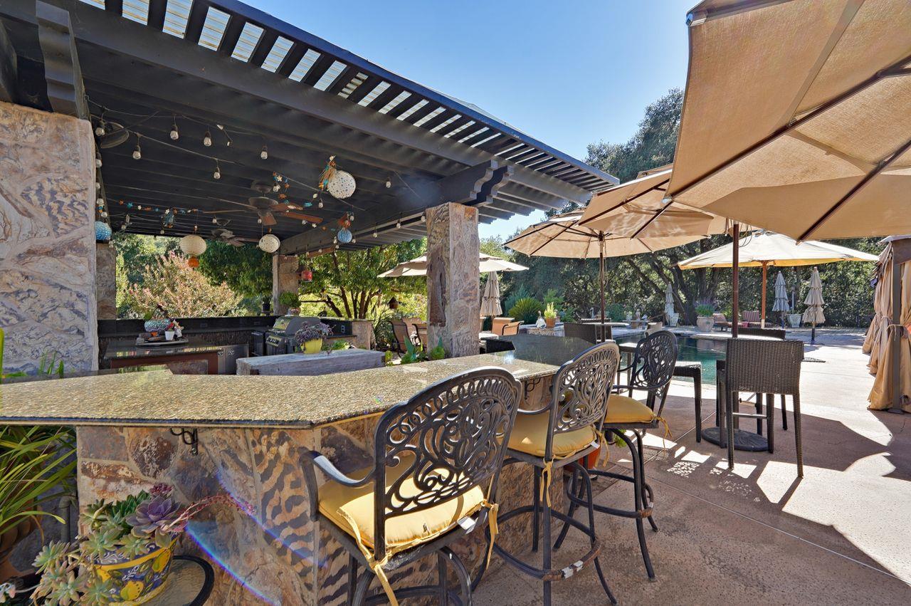 5000 Hecker Pass Road Gilroy, CA 95020 - Photo 55 of 100 a view of a patio with a table and chairs under an umbrella