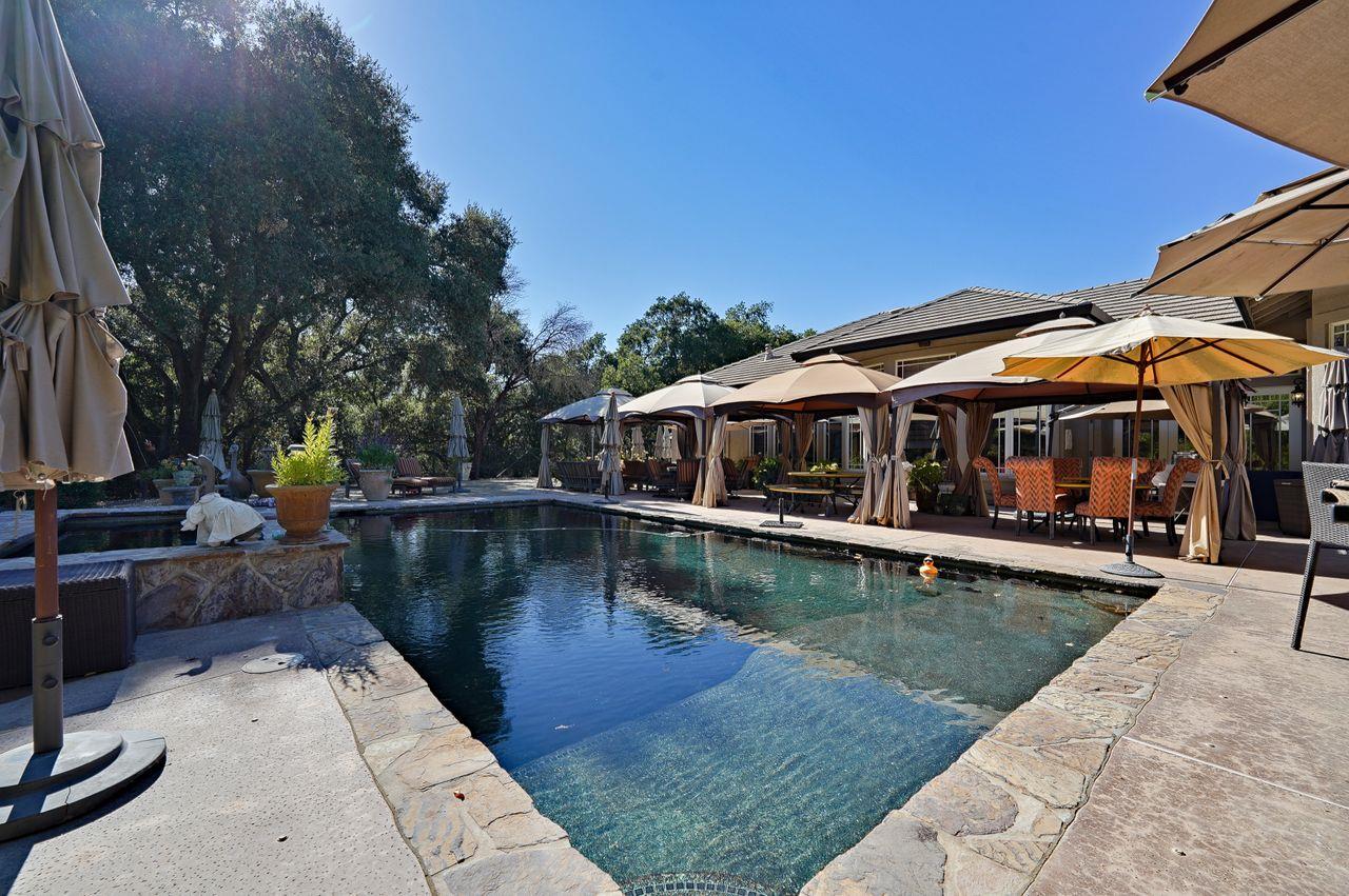 5000 Hecker Pass Road Gilroy, CA 95020 - Photo 57 of 100 a view of a swimming pool with lounge chairs in patio