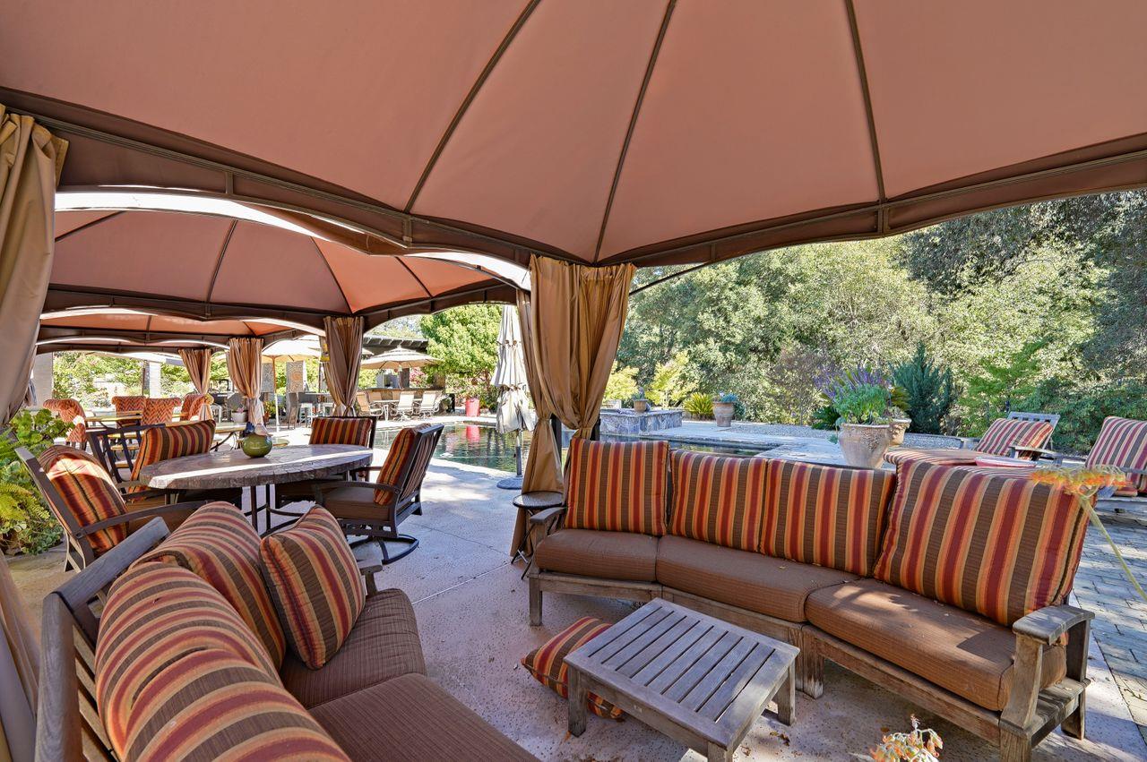 5000 Hecker Pass Road Gilroy, CA 95020 - Photo 62 of 100 a view of patio with a table and chairs under an umbrella