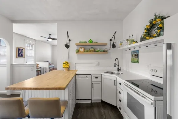 a kitchen with a sink stove and cabinets