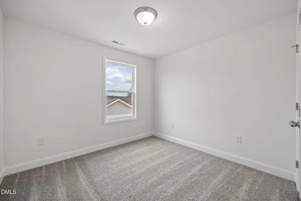 an empty room with closet and wooden floor