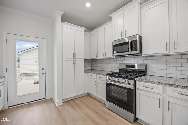a kitchen with stainless steel appliances granite countertop a stove and a sink