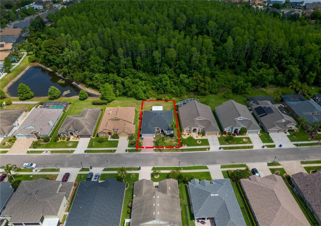 an aerial view of residential houses with outdoor space and street view