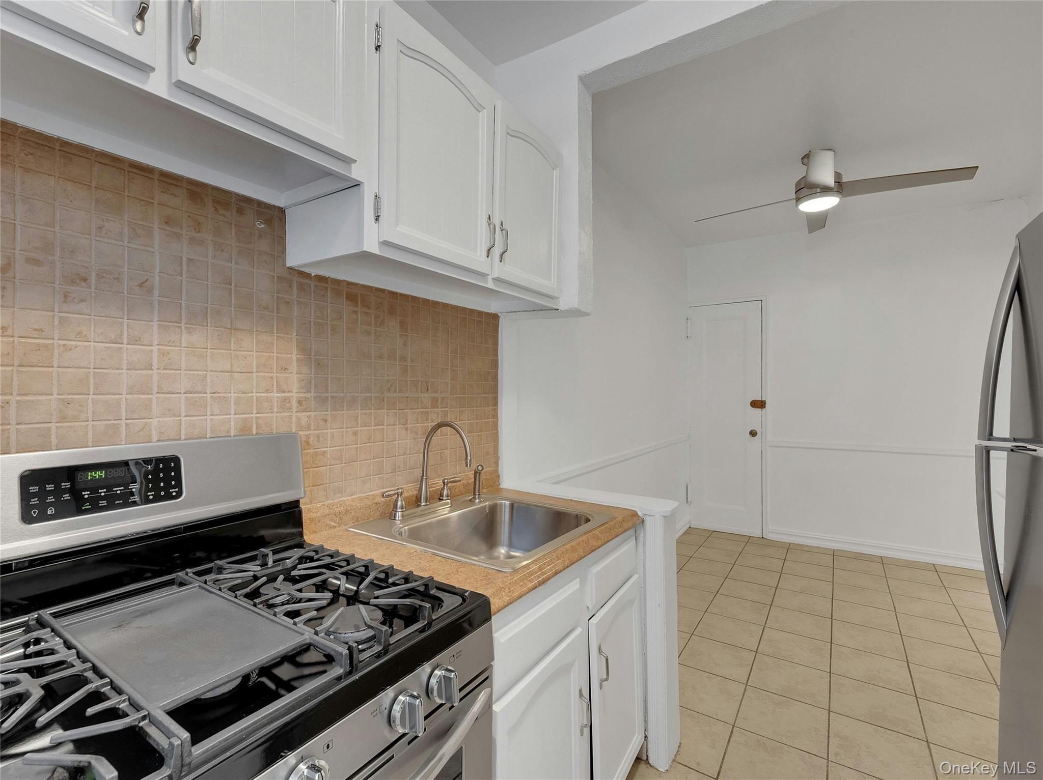 764 Palmer Road, Unit 1B Bronxville, NY 10708 - Photo 12 of 29 a kitchen with granite countertop a stove sink and cabinets