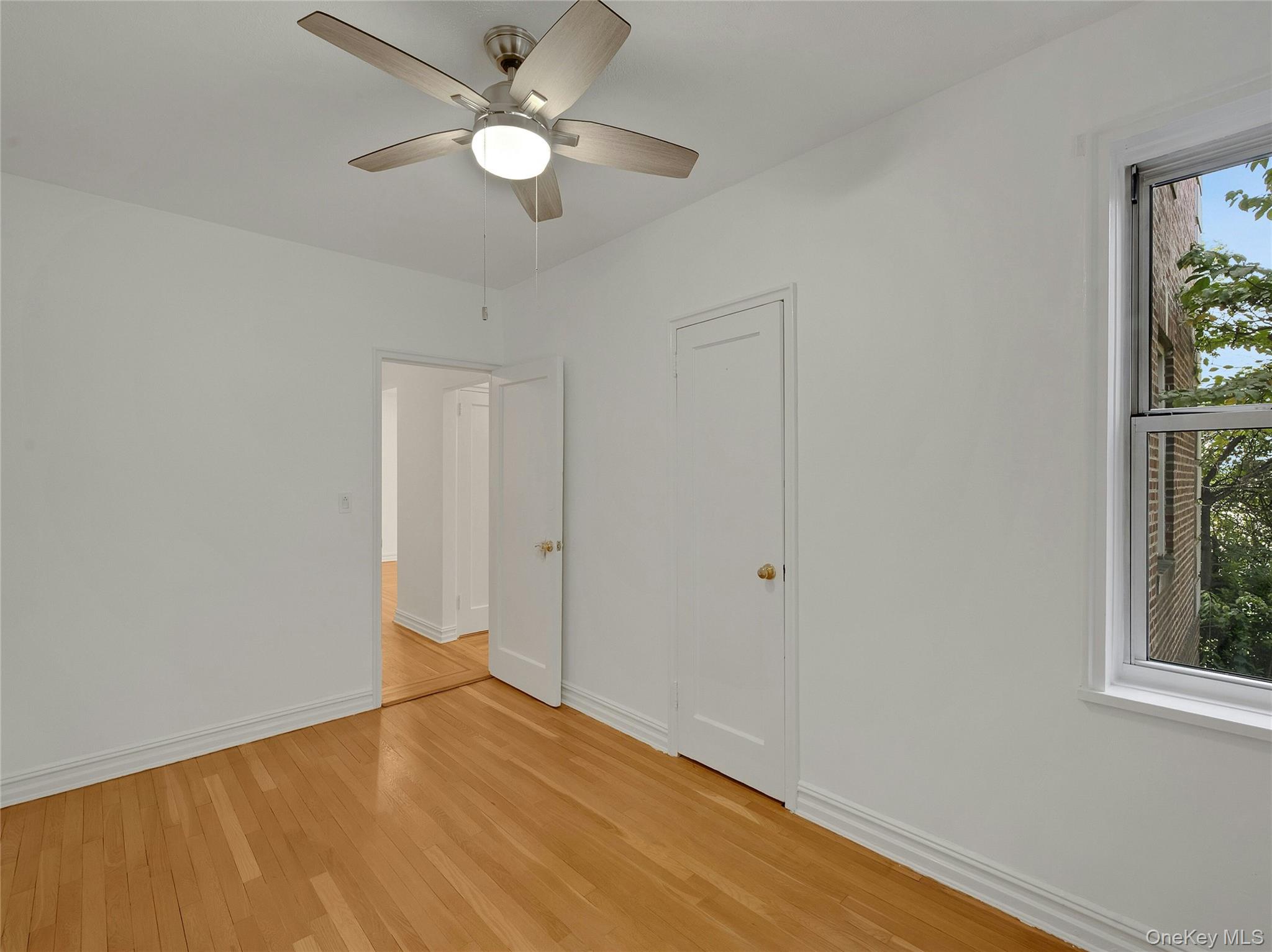 764 Palmer Road, Unit 1B Bronxville, NY 10708 - Photo 17 of 29 an empty room with fan and windows