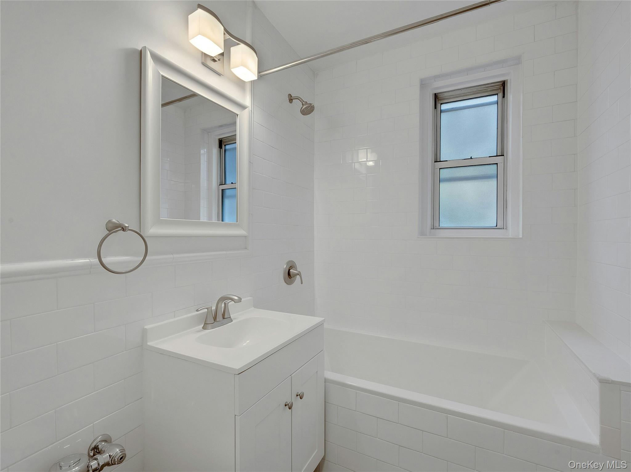 764 Palmer Road, Unit 1B Bronxville, NY 10708 - Photo 20 of 29 a bathroom with a sink a mirror and a shower