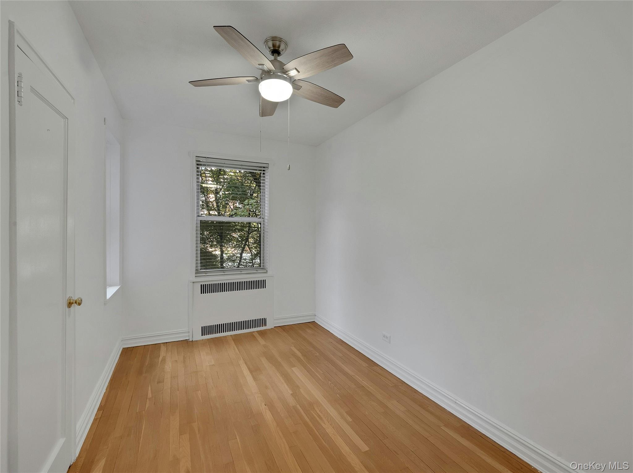 764 Palmer Road, Unit 1B Bronxville, NY 10708 - Photo 21 of 29 an empty room with wooden floor and windows