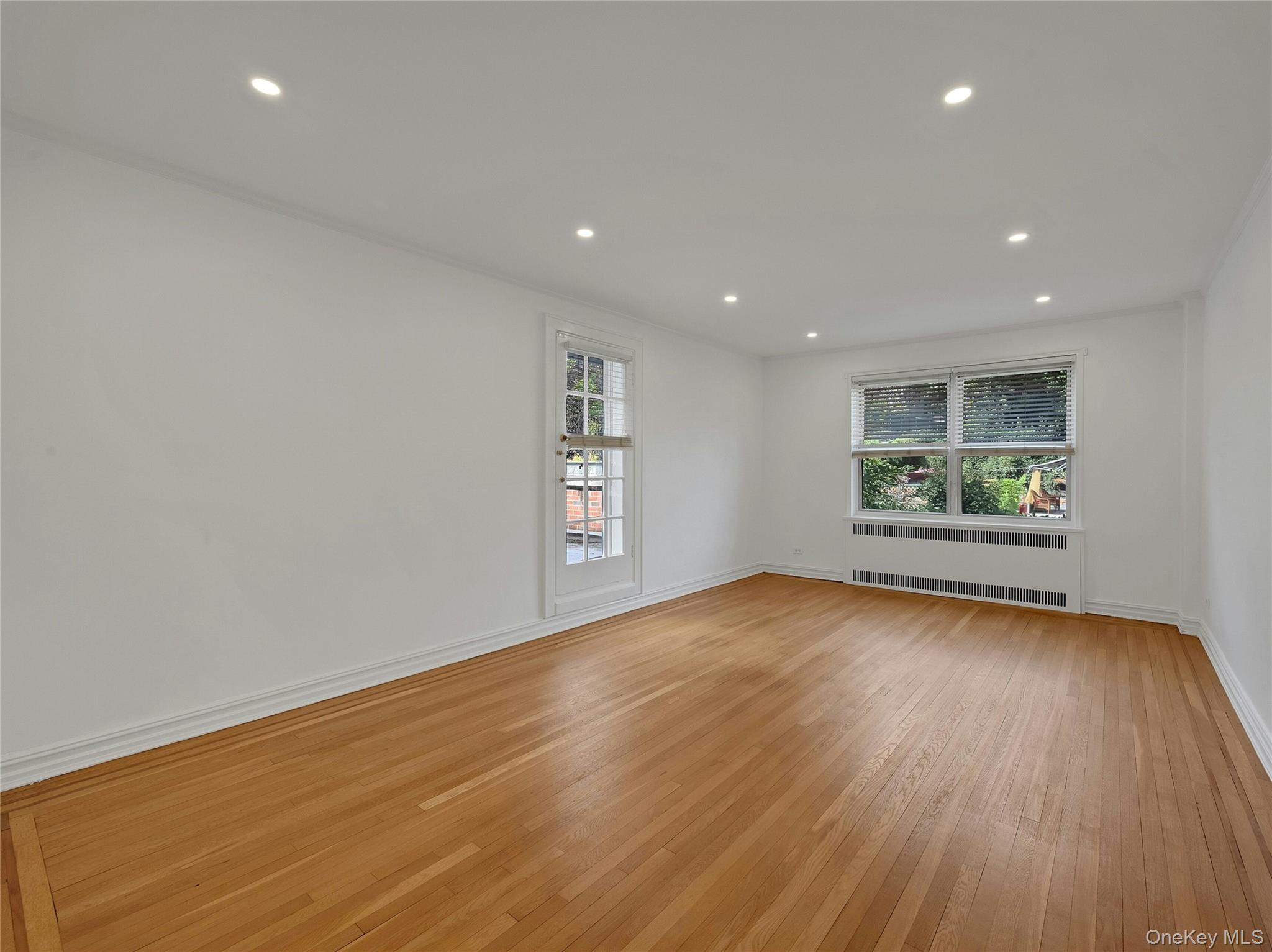 764 Palmer Road, Unit 1B Bronxville, NY 10708 - Photo 6 of 29 an empty room with wooden floor and windows