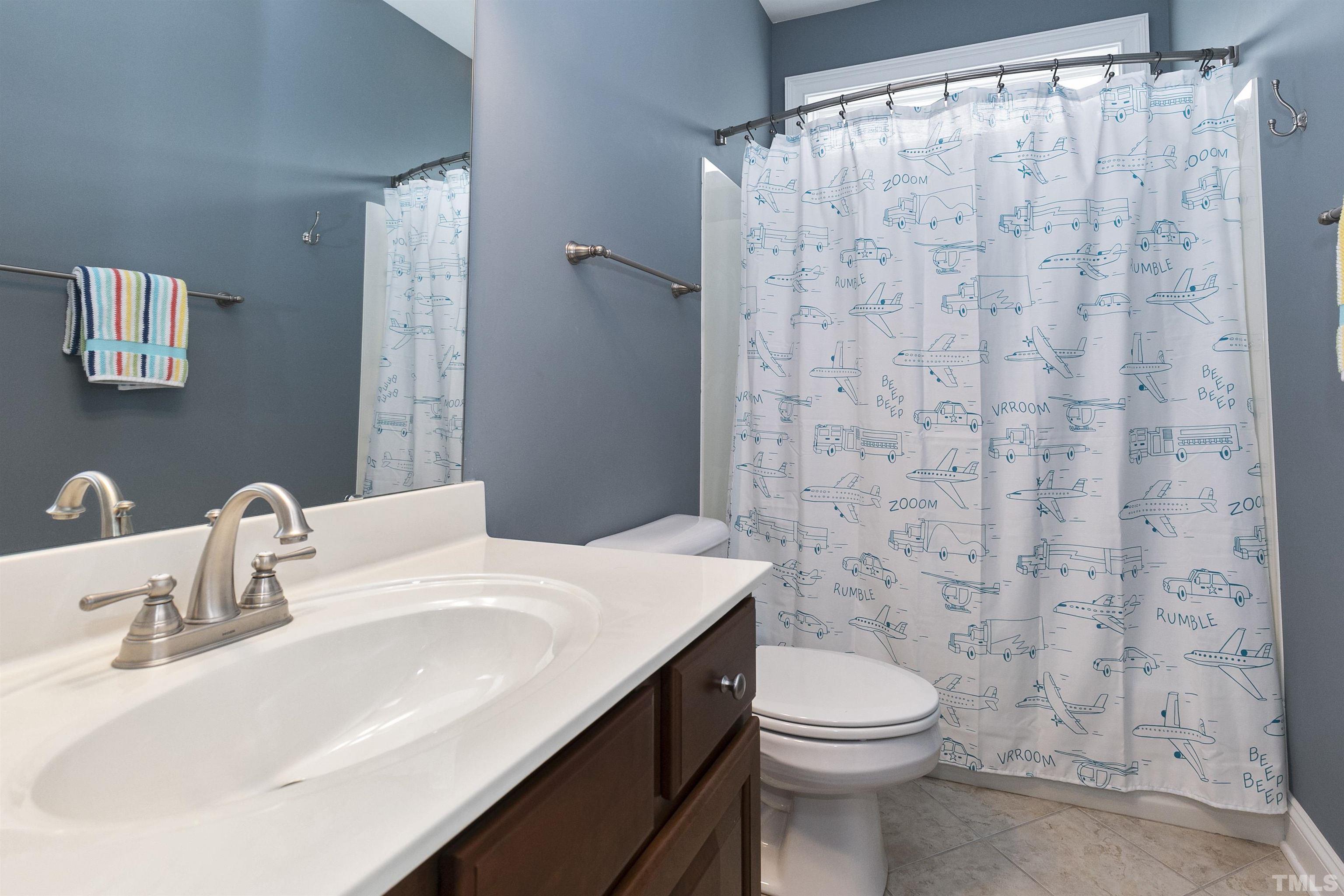 2255 Clayette Court Raleigh, NC 27612 - Photo 38 of 59 a bathroom with a sink a toilet and shower curtain