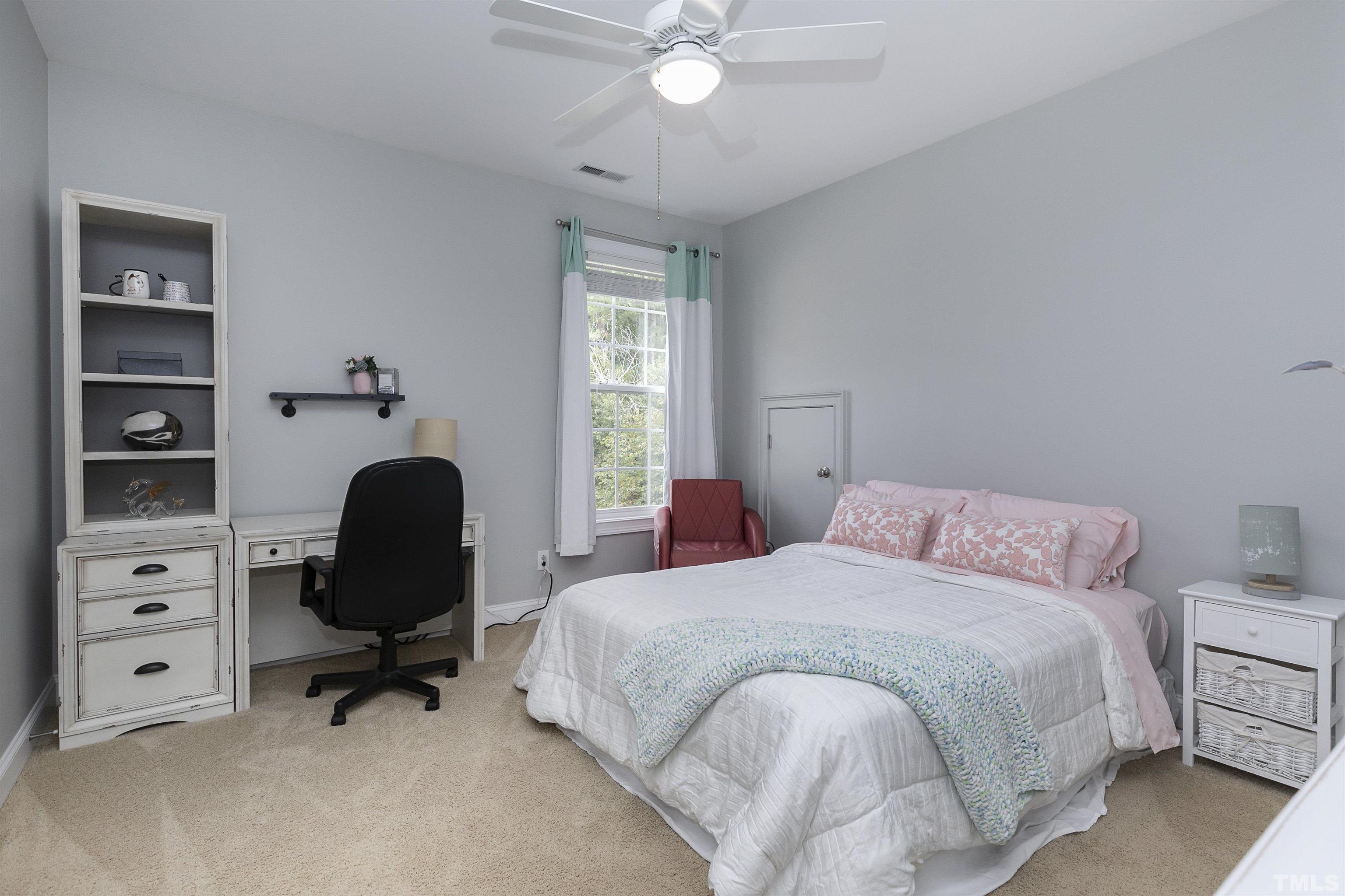 2255 Clayette Court Raleigh, NC 27612 - Photo 42 of 59 a bedroom with a bed and a chandelier