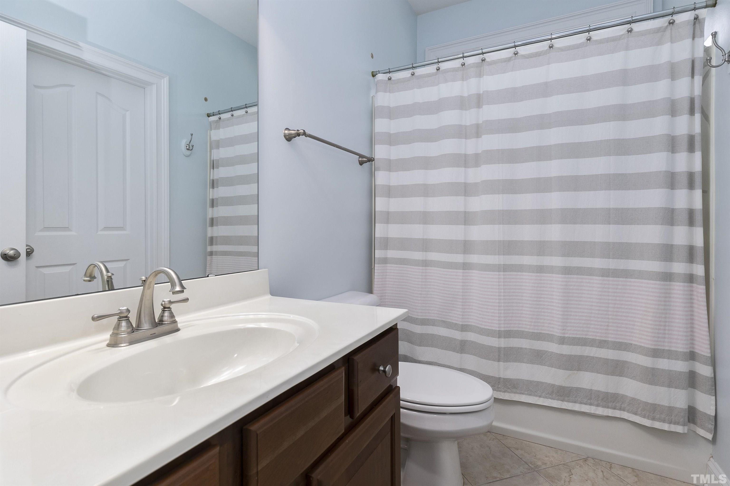 2255 Clayette Court Raleigh, NC 27612 - Photo 43 of 59 a bathroom with a sink a toilet and shower curtain