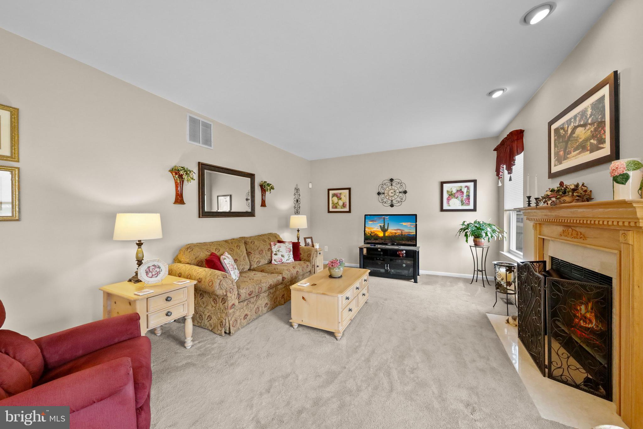 7 Colts Gait Road Evesham, NJ 08053 - Photo 12 of 47 a living room with furniture a fireplace and a flat screen tv