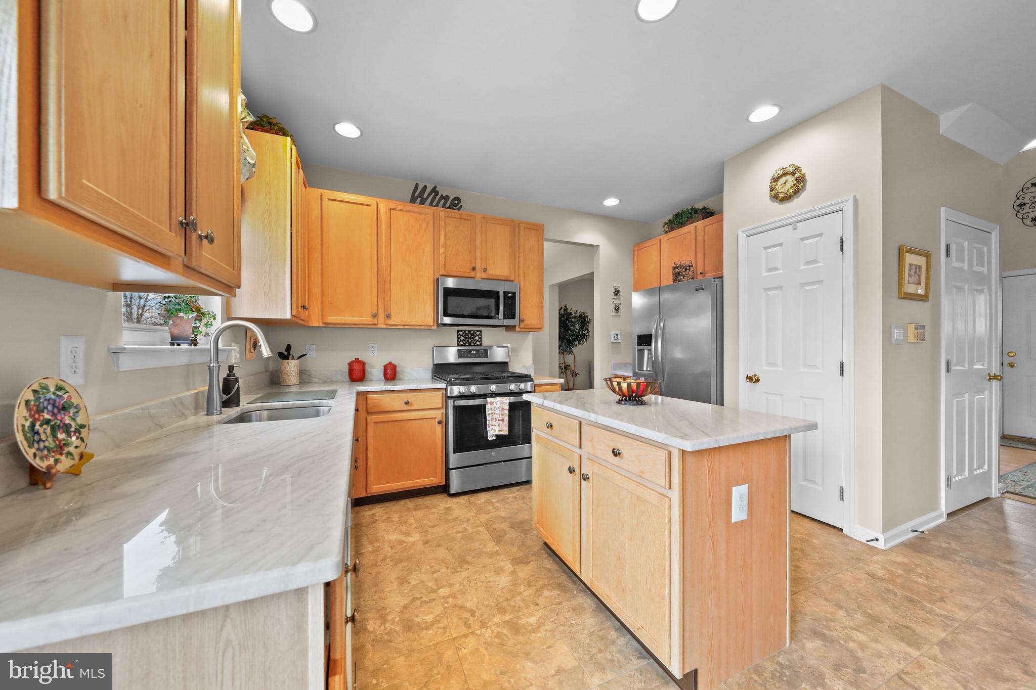 7 Colts Gait Road Evesham, NJ 08053 - Photo 9 of 47 a kitchen with a refrigerator sink and cabinets