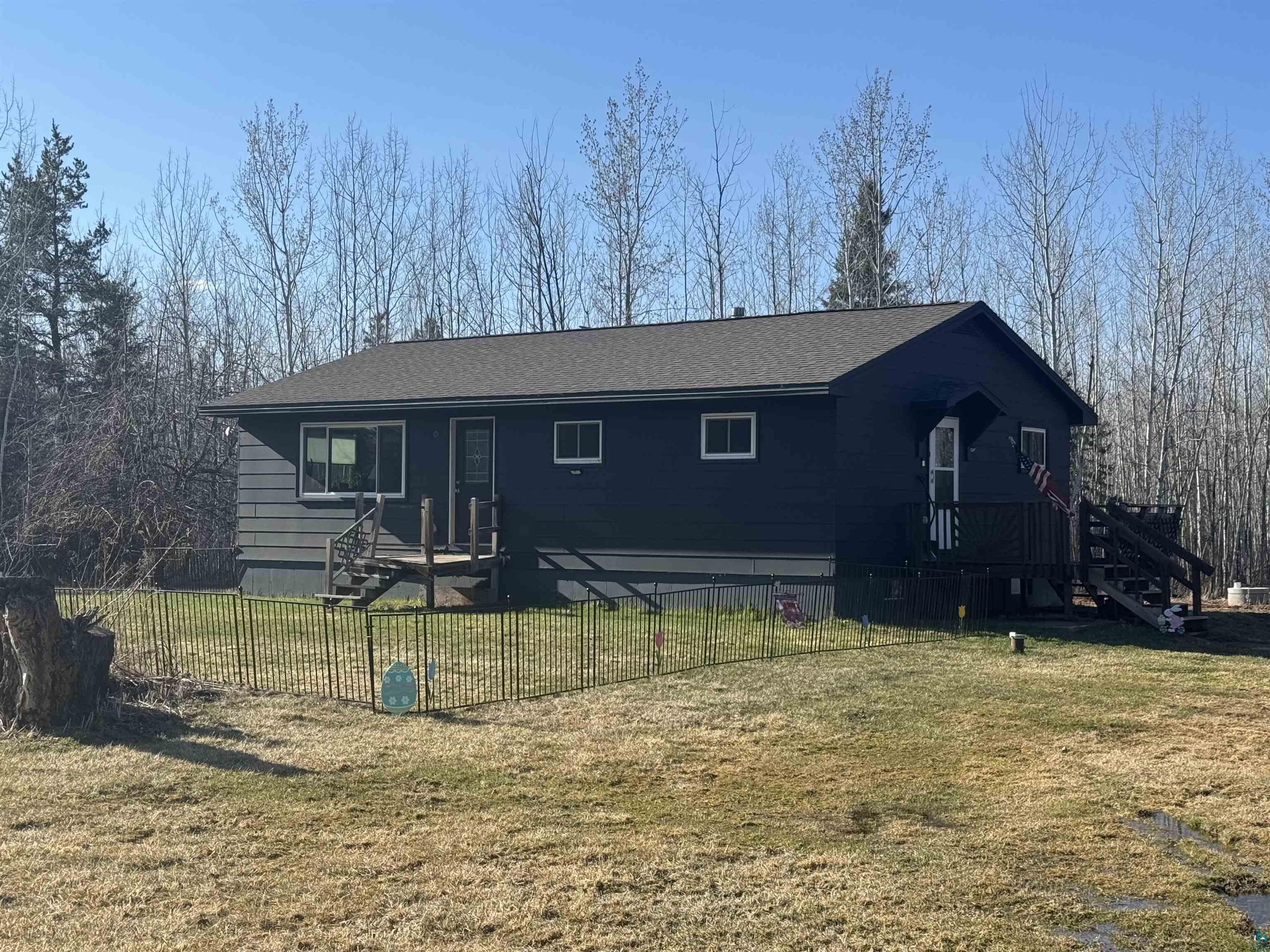 5133 East County Rd C Superior, WI 54880 - Photo 1 of 16 View of front of home with a front lawn, stairs, and fence private yard