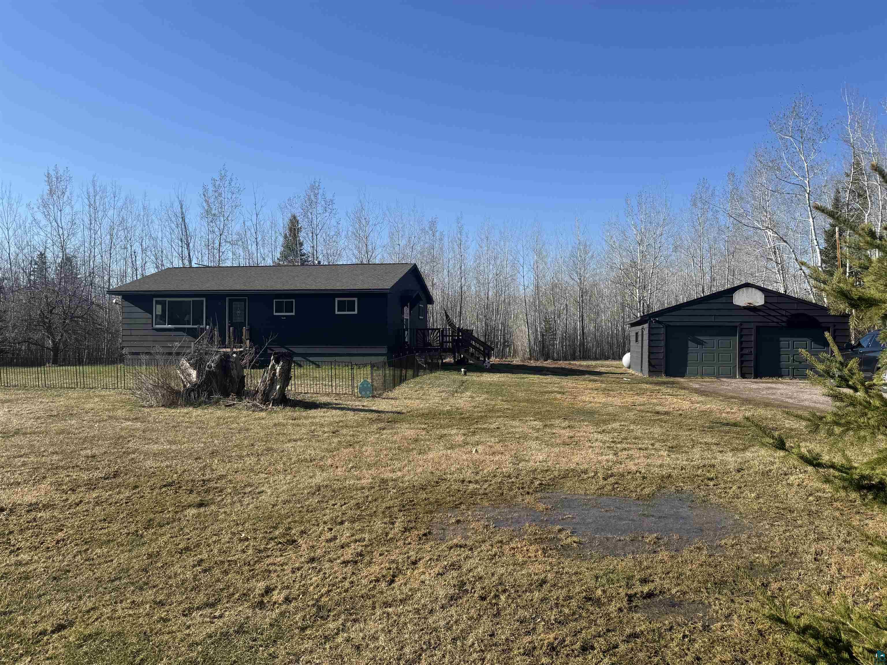 5133 East County Rd C Superior, WI 54880 - Photo 2 of 16 View of front of house featuring an outdoor structure, a front yard, and a garage