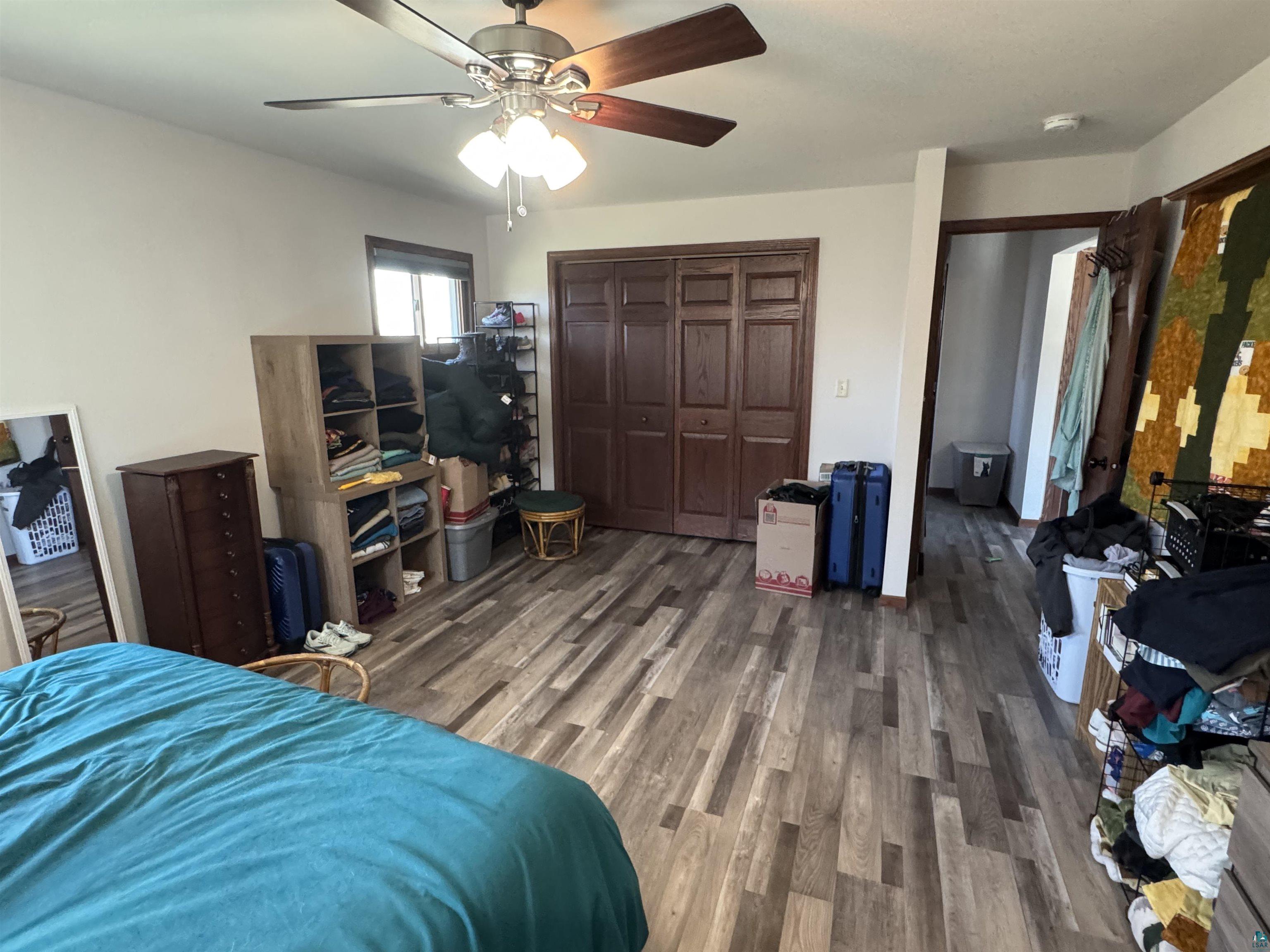 5133 East County Rd C Superior, WI 54880 - Photo 7 of 16 Bedroom with a ceiling fan, wood finished floors, and a closet