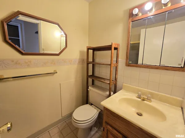 a bathroom with a sink toilet and mirror