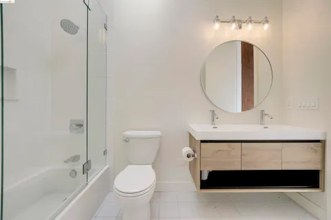 a bathroom with a sink a toilet and a mirror