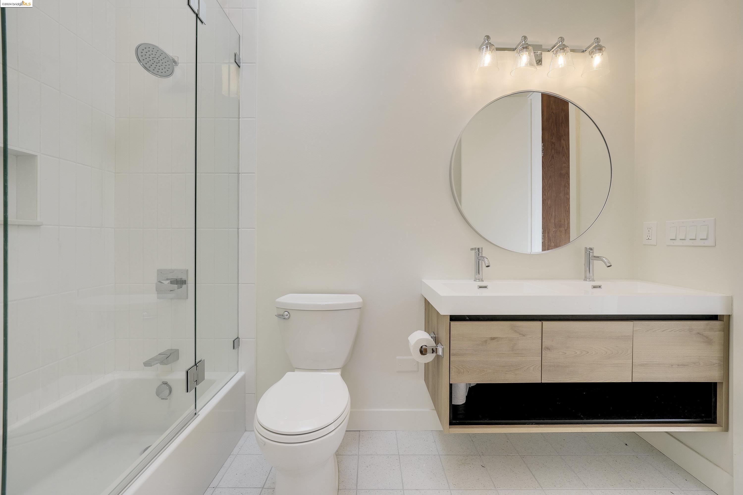 921 Clark Place El Cerrito, CA 94530 - Photo 15 of 36 a bathroom with a sink a toilet and a mirror