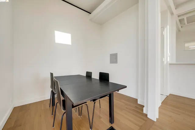 a view of a workspace with furniture and wooden floor