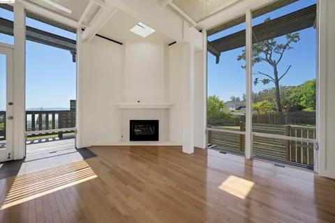 a view of a porch with wooden floor and fence