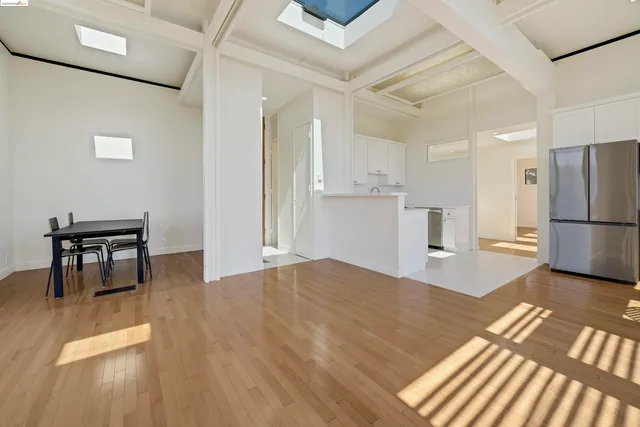 a kitchen with a refrigerator and a table chair