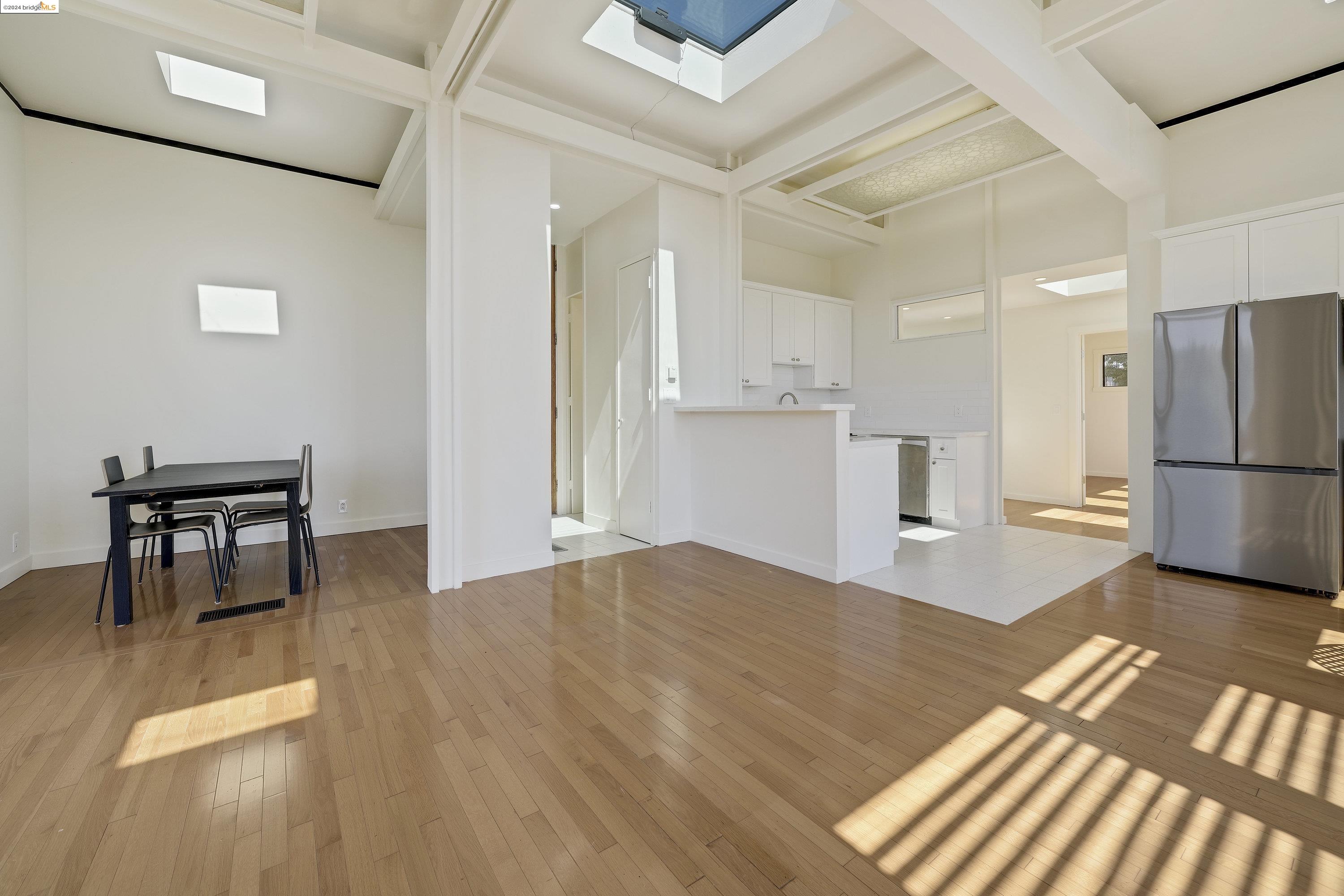 921 Clark Place El Cerrito, CA 94530 - Photo 20 of 36 a kitchen with a refrigerator and a table chair