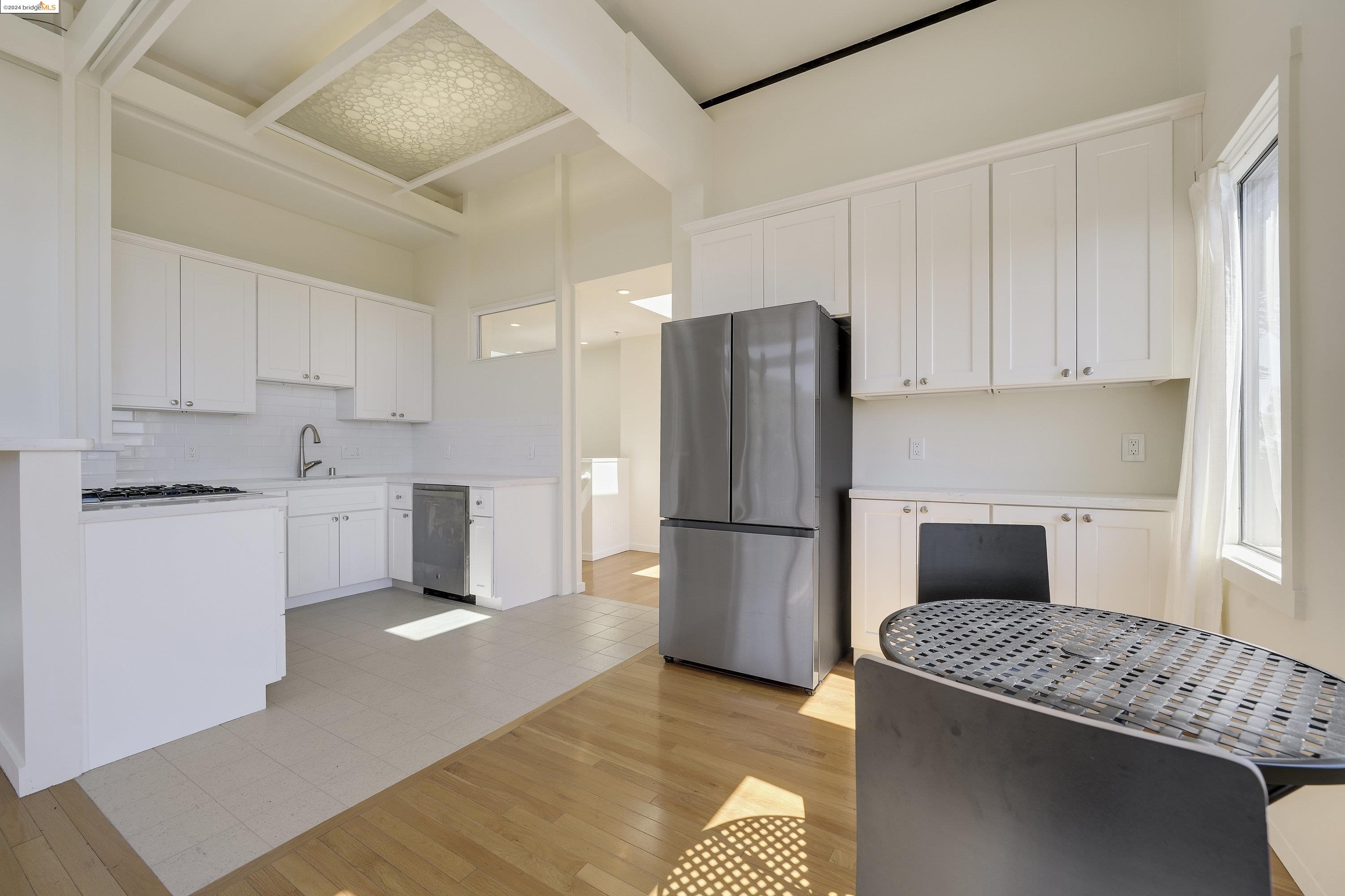 921 Clark Place El Cerrito, CA 94530 - Photo 21 of 36 a kitchen with a refrigerator sink and cabinets
