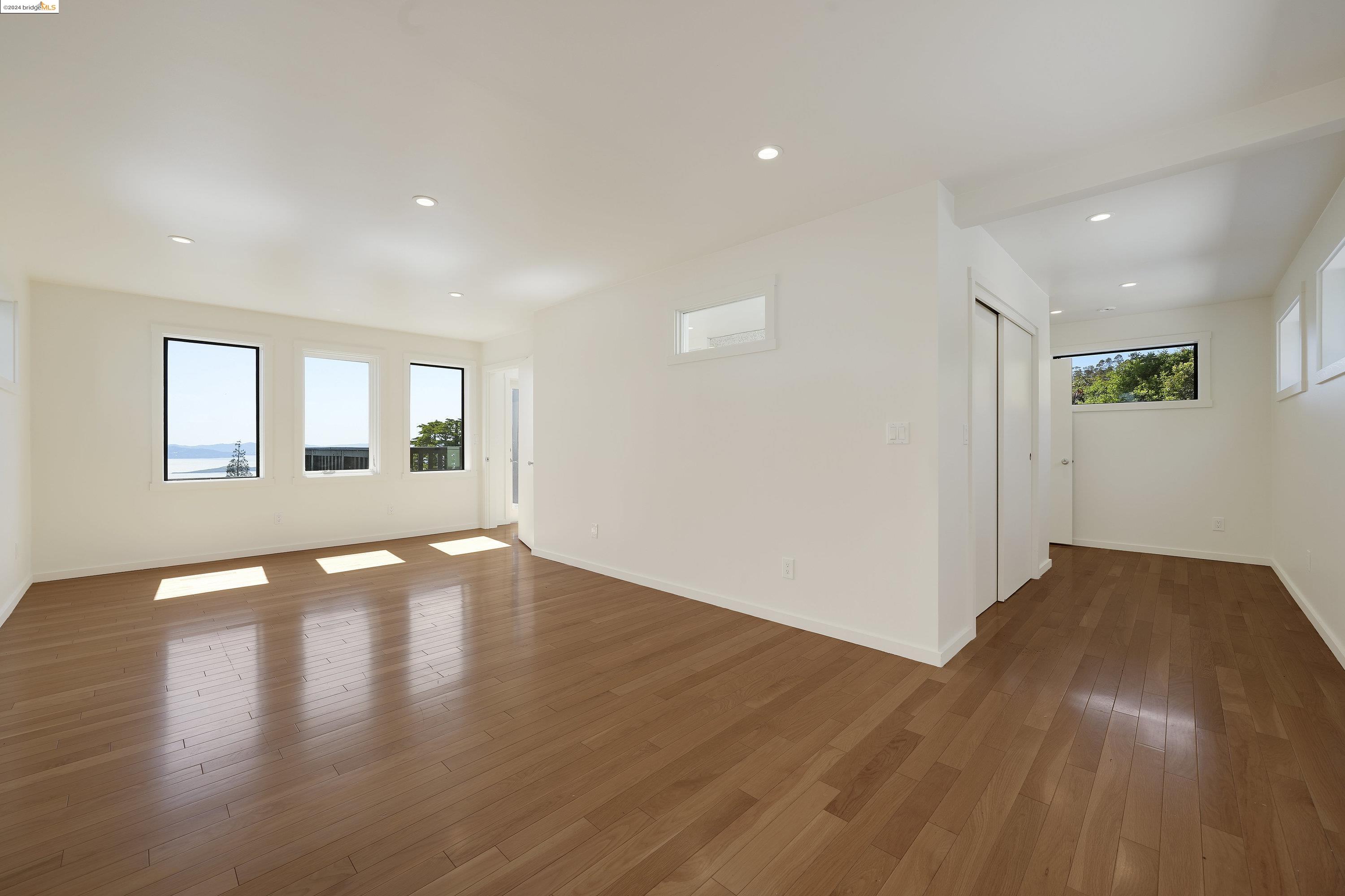 921 Clark Place El Cerrito, CA 94530 - Photo 28 of 36 a view of an empty room with wooden floor and a window