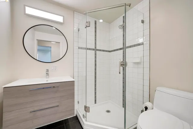 a bathroom with a sink a toilet and a mirror