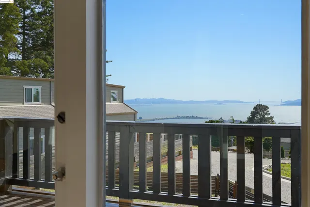 a balcony with wooden floor and fence
