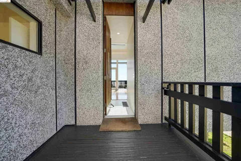 a view of a balcony with wooden floor