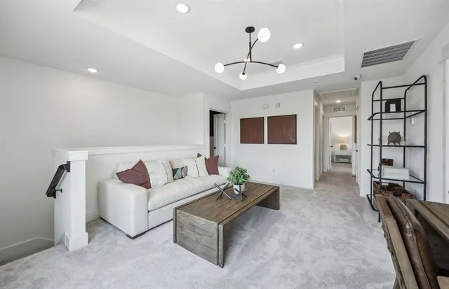 a living room with furniture and a chandelier
