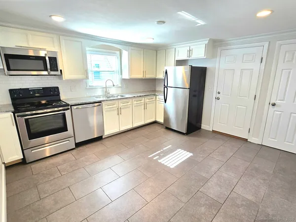 a kitchen with refrigerator and microwave
